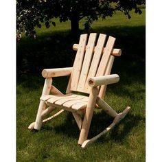 a wooden chair sitting in the grass