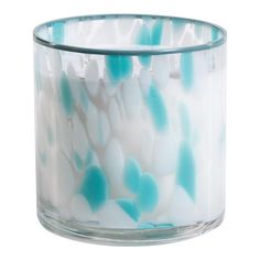 a glass candle holder filled with blue and white hearts