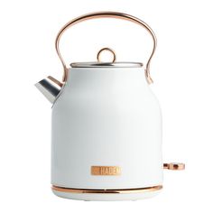 a white tea kettle with a gold handle and the word haden on it's side