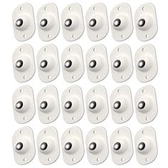 twelve white buttons with black dots on each one and two holes in the middle, all facing different directions