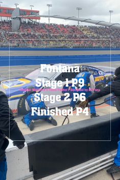 two men working on a race car in front of an audience at a nascar event