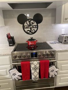 a kitchen with an oven, stove and mickey mouse sign