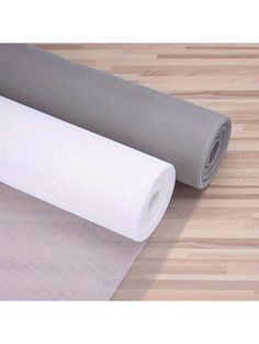 two different types of yoga mats on a wooden floor