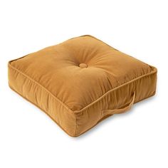 the square cushion is made out of brown fabric