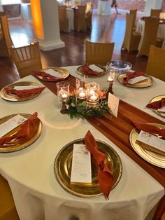 the table is set with candles and place settings