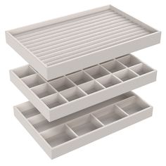 two white trays with dividers are stacked on top of each other in the shape of drawers