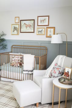 a baby's room with pictures on the wall and a crib in the corner