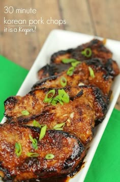 korean pork chops on a white plate with green napkin