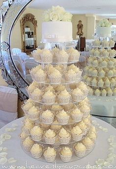 a wedding cake with cupcakes stacked on top