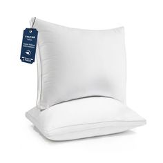 the pillow is white and has a tag hanging from it's back end,