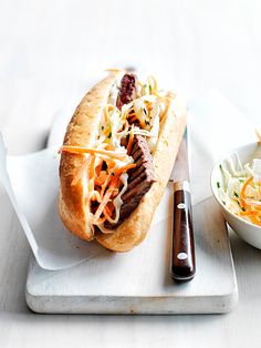 a hot dog on a bun with coleslaw and slaw