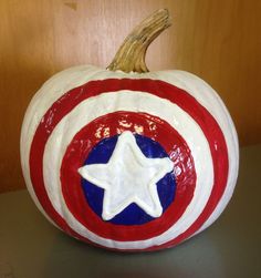 a painted captain america pumpkin sitting on top of a table