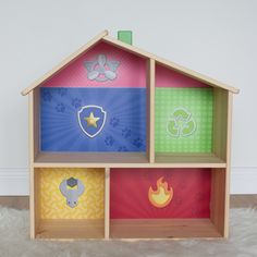 a wooden toy house with different colors and shapes