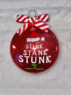 a red ornament with the words stink st stanc stunk on it