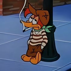 a cartoon character sitting on the ground next to a lamp post