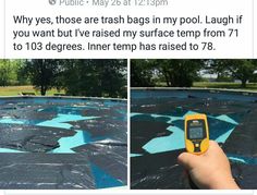 a hand holding a thermometer in front of a tarp covered swimming pool