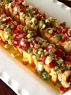 a white plate topped with food on top of a wooden table