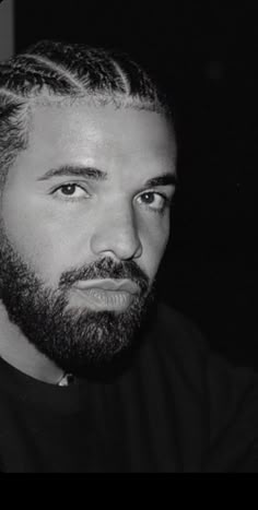 a black and white photo of a man with a beard