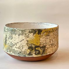 a white and brown bowl sitting on top of a table