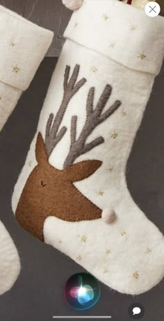 a christmas stocking hanging from a pole with reindeer's head and antlers on it