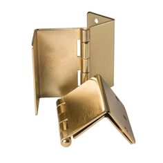 an open brass plated door hinge on a white background