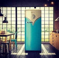 a blue and white refrigerator sitting inside of a kitchen