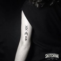 a black and white photo of a person with a tattoo on their arm that says sketchink