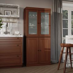 a kitchen area with wooden cabinets and counter tops, white walls and wood flooring