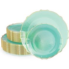 three green plates stacked on top of each other with gold rims and saucers