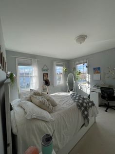 a bed room with a neatly made bed and two windows