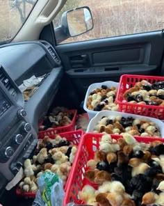 several red baskets filled with food in the back seat of a car's dashboard