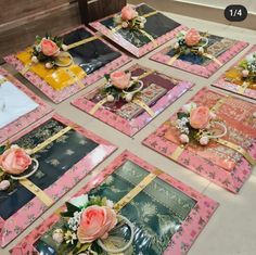 there are many cards on the table with flowers and ribbons around them that have been placed together