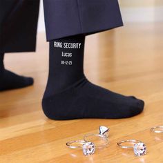 This super cool design for the ring bearer is printed on our black or navy flat knit dress socks or white ribbed crew socks and makes a great wedding accessory and gift. Please enter the name and wedding date to be printed on the socks. Orders with missing information will take longer to process. Personalize a pair of socks for the special day by adding the name and wedding date to the socks. Sock size 6-8 1/2 fits a kids shoe size 9-2, ages 5-9 Cotton/nylon blend Machine wash warm, bleach produ Ring Bearer Navy, Wedding Socks Boldsocks, Ring Security Wedding, Wedding Socks Black Nfl, Dark Purple Bridal Party Socks, Groom Socks, Navy Flats, Groomsmen Socks, Ring Bearer Gifts