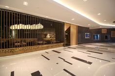 an empty lobby with black and white tile flooring