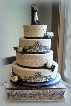 a three tiered wedding cake sitting on top of a table