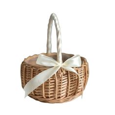 a wicker basket with a white ribbon tied around the handle and bottom, on a white background