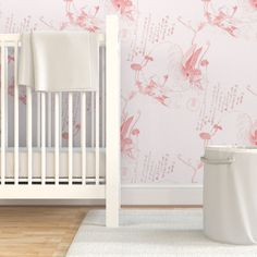 a white crib in front of a wallpapered nursery