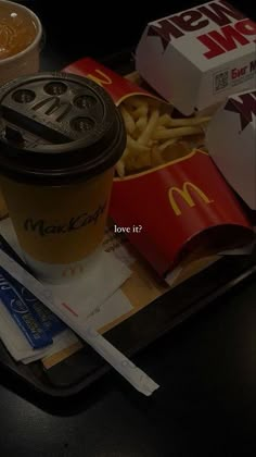 a tray with fries, hotdogs and drink sitting on top of each other