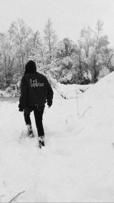 a person walking in the snow with skis and poles on their feet while wearing a jacket