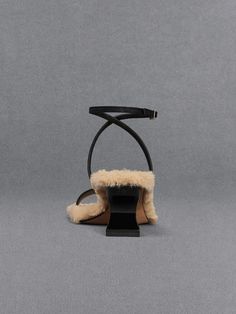 This item is part of our Online Exclusive selection, which consists of unique colourways and designs that are only available for purchase at CHARLESKEITH.COM. These elevated open-toed sandals are hard to miss. Black leather straps are contrasted against a soft fur lining to create a dynamic, standout silhouette. The breathable open-toed style lends casual flair to the sandals, making them adaptable for dressy occasions and weekend outings alike. Adjustable ankle-straps offer a flattering fit, which is enhanced by the leg-lengthening effect of the sculptural heels. To make a striking statement, add these to your outfits for an unexpected, distinctive element. Sculptural Heels, Fur Heels, Ankle Strap Sandals Heels, Size Chart For Kids, Black Sandals Heels, Sheep Leather, Ankle Strap Heels, Ankle Straps, Heeled Sandals