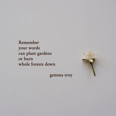 a white flower sitting on top of a piece of paper next to a poem that reads, remember your words can plant gardens or burn