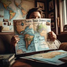 a woman holding up a map with the words travel taht davidi on it