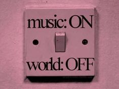 a pink light switch cover with the words music on world off written in black and white