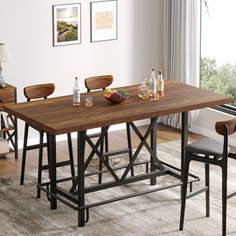 a dining table with four chairs and a bowl of fruit