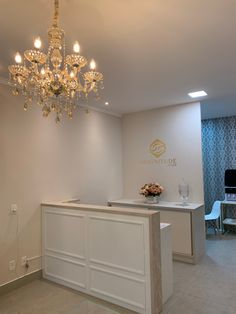 a white counter top sitting under a chandelier