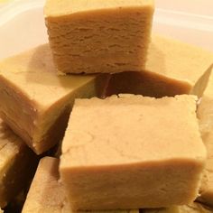 several pieces of cake sitting on top of each other in a plastic container with a knife