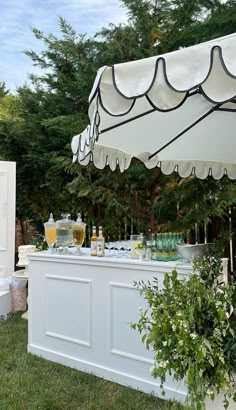 an outdoor bar is set up with drinks on it