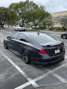 a black car is parked in the parking lot