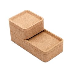 two cork coasters sitting side by side on top of each other in front of a white background