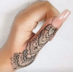 a woman's hand with a tattoo on it